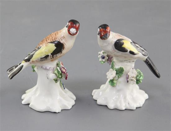 A near pair of Derby figures of goldfinches, c.1765-70, h. 6.3 and 6.5cm, one restored